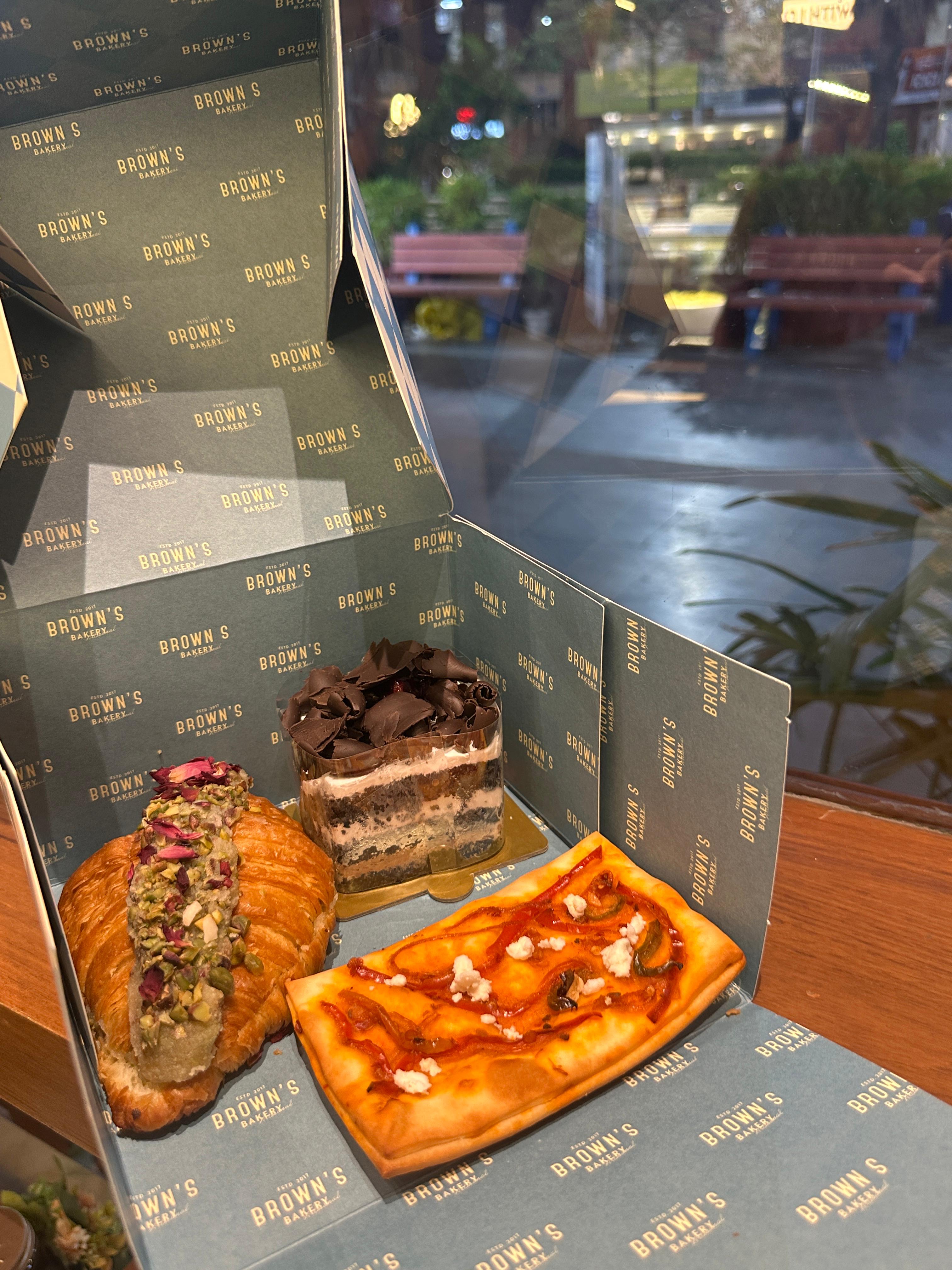 A Brown's Bakery mystery box packed with a pistachio croissant, tiramisu jar and a chilli cheese tart