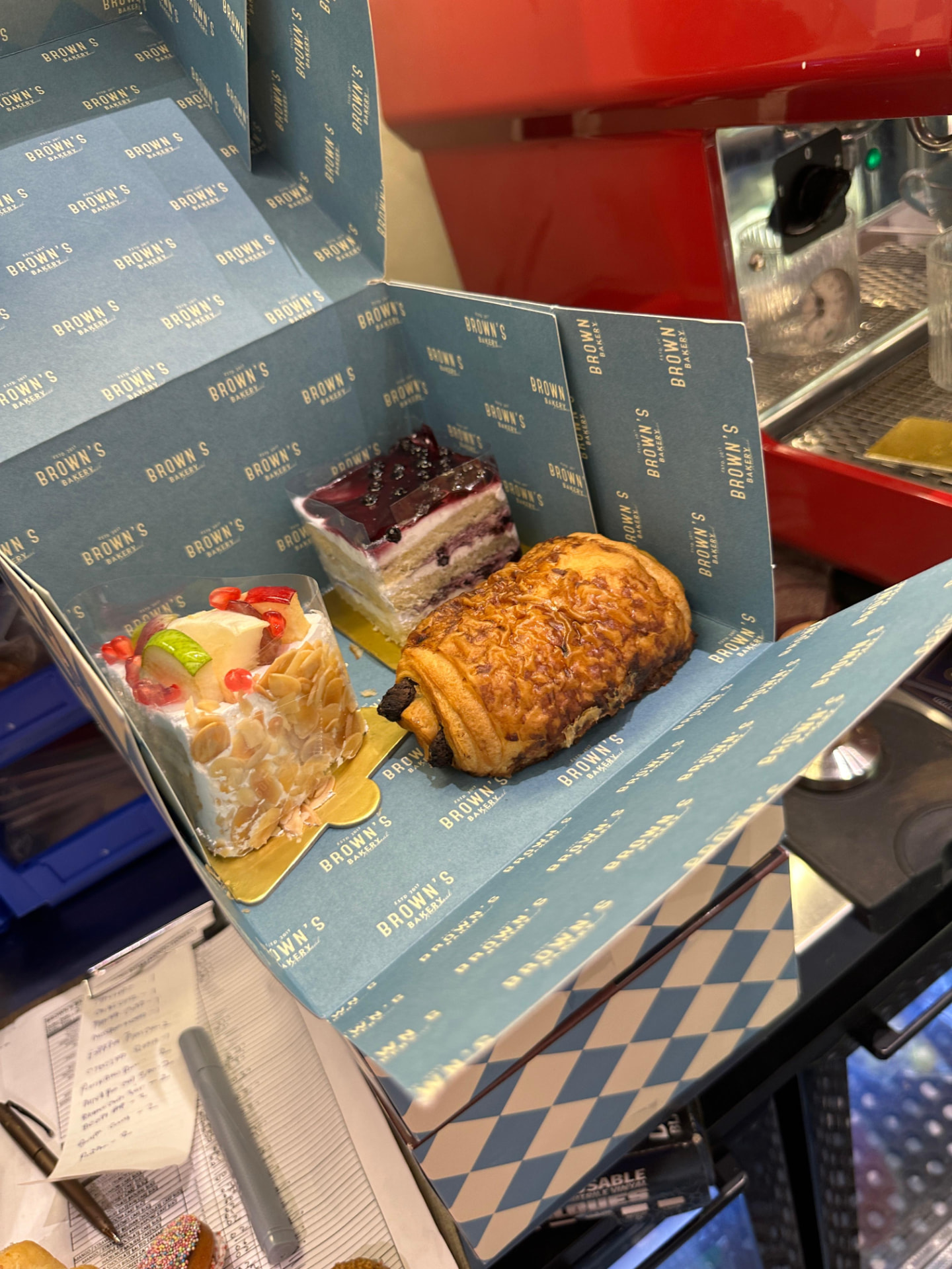 A Brown's Bakery box being packed at the counter in Nirvana Courtyard